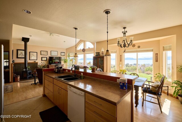 41293 Crested Crane St, Homer, AK 99603 - kitchen with a sink, white dishwasher, dark countertops, open floor plan, and a wood stove
