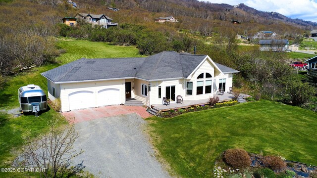 41293 Crested Crane St, Homer, AK 99603 - view of front of home with driveway, a front lawn, an attached garage, and a deck with mountain view