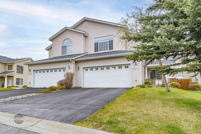 2823 Discovery Bay Dr, Anchorage, AK 99515 - traditional home featuring asphalt driveway, a garage, and a front lawn
