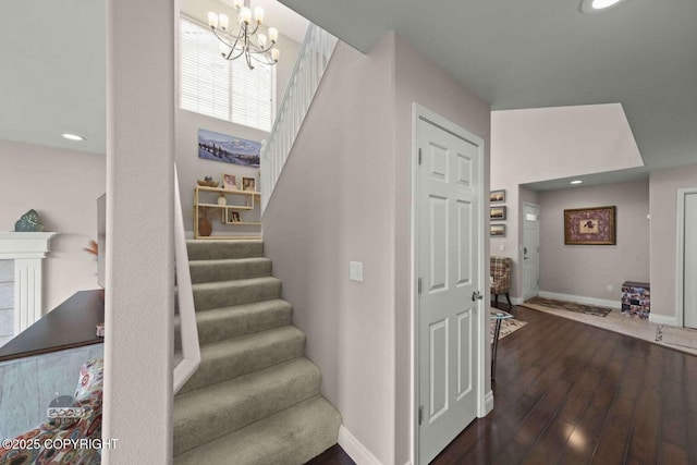 2823 Discovery Bay Dr, Anchorage, AK 99515 - staircase with wood finished floors, a chandelier, baseboards, and recessed lighting