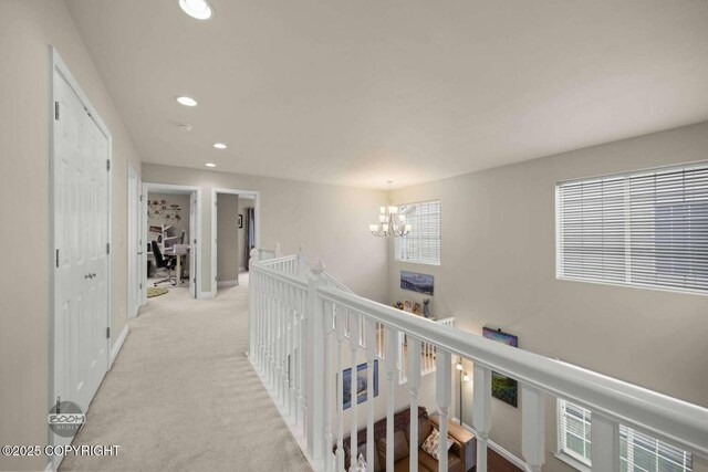2823 Discovery Bay Dr, Anchorage, AK 99515 - corridor featuring an upstairs landing, recessed lighting, a chandelier, light colored carpet, and baseboards