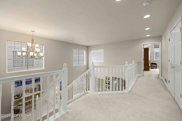 2823 Discovery Bay Dr, Anchorage, AK 99515 - hallway with an upstairs landing, a chandelier, carpet, and recessed lighting