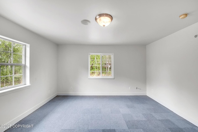 1151 W Gail Dr, Wasilla, AK 99654 - spare room featuring plenty of natural light, carpet, baseboards, and a smoke detector