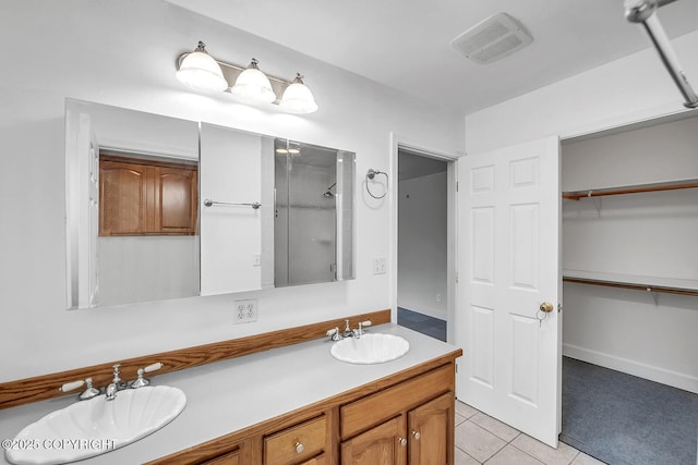 1151 W Gail Dr, Wasilla, AK 99654 - bathroom featuring an enclosed shower, tile patterned floors, a walk in closet, and double vanity