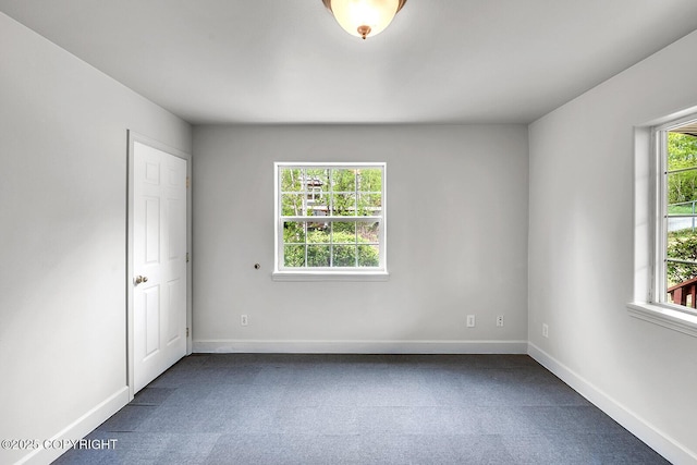 1151 W Gail Dr, Wasilla, AK 99654 - spare room featuring dark colored carpet and baseboards