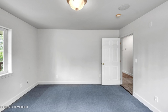 1151 W Gail Dr, Wasilla, AK 99654 - empty room featuring baseboards, dark carpet, and a smoke detector
