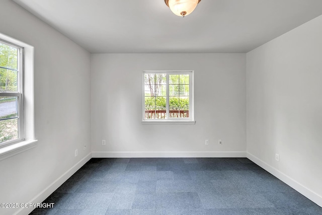 1151 W Gail Dr, Wasilla, AK 99654 - unfurnished room with healthy amount of natural light, dark carpet, and baseboards