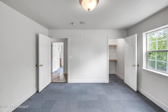 1151 W Gail Dr, Wasilla, AK 99654 - unfurnished bedroom featuring baseboards and a walk in closet