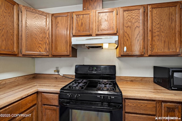 1031 E Dunedin St, Wasilla, AK 99654 - kitchen with black appliances, under cabinet range hood, butcher block counters, and brown cabinets