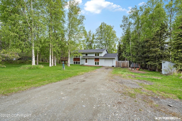 1031 E Dunedin St, Wasilla, AK 99654 - view of front facade featuring dirt driveway, an attached garage, and roof with shingles