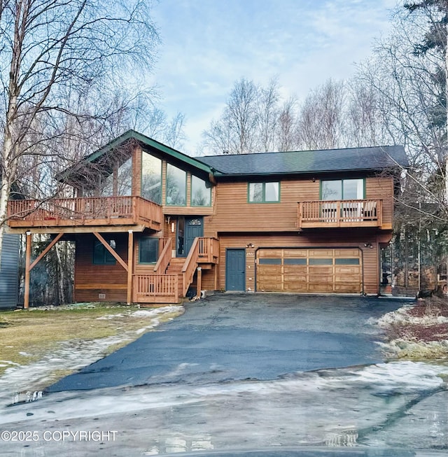 2921 Rocky Bay Cir, Anchorage, AK 99515 - view of front of property featuring an attached garage, driveway, stairs, and a sunroom
