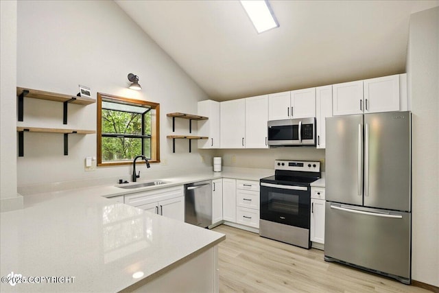2921 Rocky Bay Cir, Anchorage, AK 99515 - kitchen featuring appliances with stainless steel finishes, open shelves, a sink, lofted ceiling, and light countertops