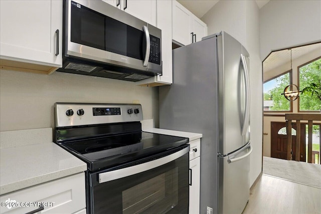 2921 Rocky Bay Cir, Anchorage, AK 99515 - kitchen featuring stainless steel appliances and white cabinetry