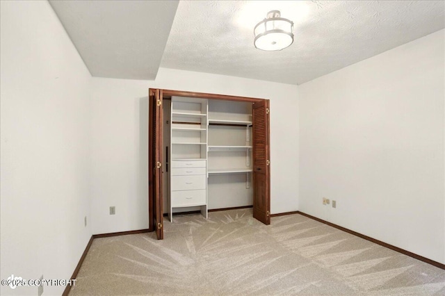 2921 Rocky Bay Cir, Anchorage, AK 99515 - unfurnished bedroom featuring light carpet, baseboards, and a closet