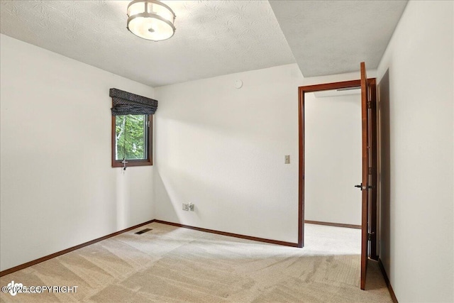 2921 Rocky Bay Cir, Anchorage, AK 99515 - carpeted spare room with baseboards and a textured ceiling