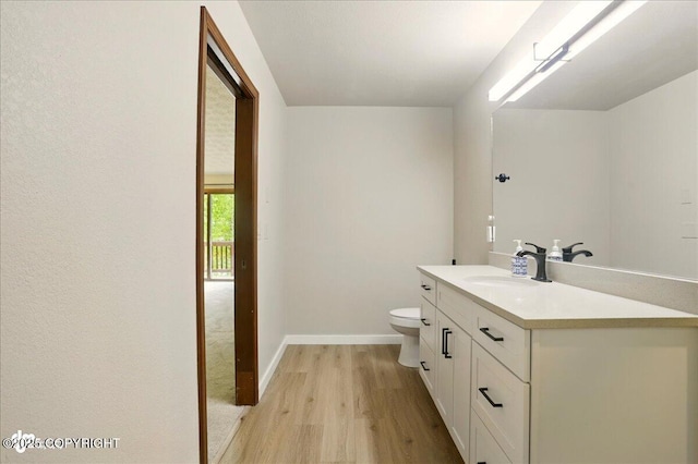 2921 Rocky Bay Cir, Anchorage, AK 99515 - bathroom with wood finished floors, vanity, toilet, and baseboards