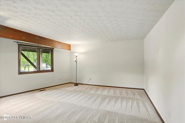 2921 Rocky Bay Cir, Anchorage, AK 99515 - carpeted empty room with baseboards, a textured ceiling, and beam ceiling