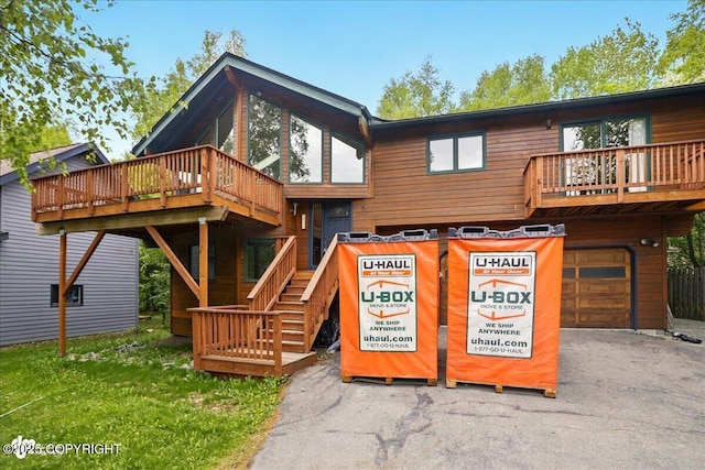 2921 Rocky Bay Cir, Anchorage, AK 99515 - view of front of home featuring a garage, driveway, a deck, and stairs