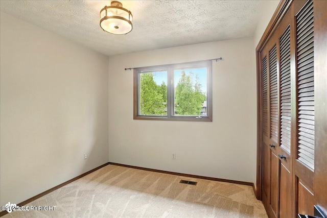 2921 Rocky Bay Cir, Anchorage, AK 99515 - unfurnished bedroom with a closet, baseboards, and light carpet