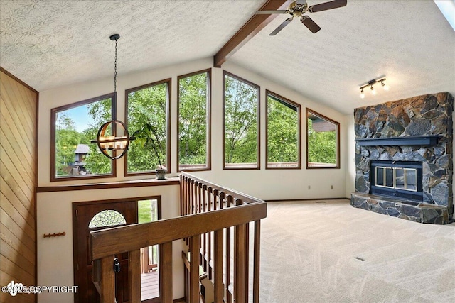 2921 Rocky Bay Cir, Anchorage, AK 99515 - unfurnished living room featuring a textured ceiling, healthy amount of natural light, wooden walls, ceiling fan, and carpet floors