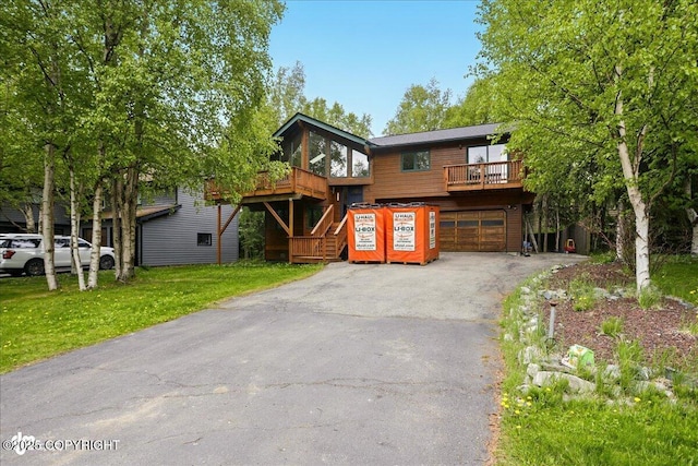 2921 Rocky Bay Cir, Anchorage, AK 99515 - rustic home with driveway, a garage, and a front yard