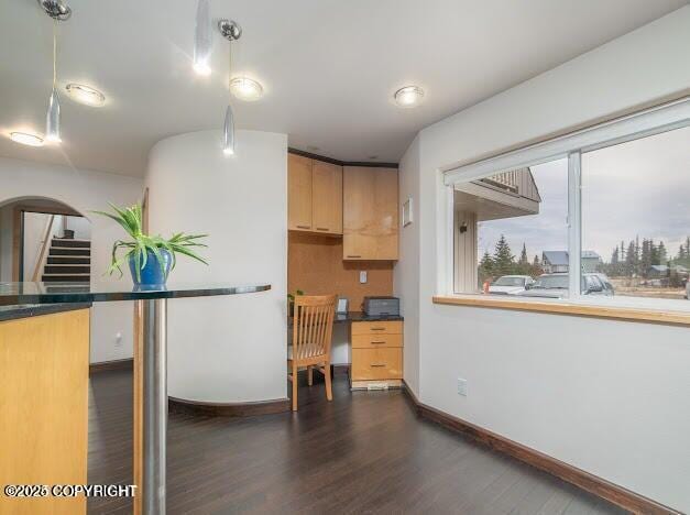 37397 Cetacea Ln, Kenai, AK 99611 - kitchen featuring dark wood-type flooring, baseboards, light brown cabinets, dark countertops, and pendant lighting