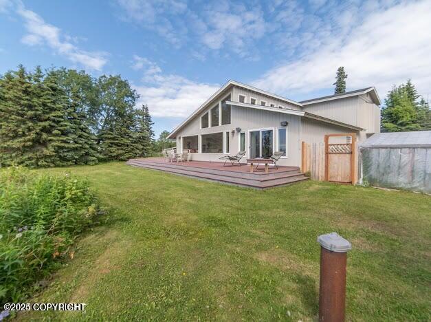 37397 Cetacea Ln, Kenai, AK 99611 - back of house with a yard and a wooden deck