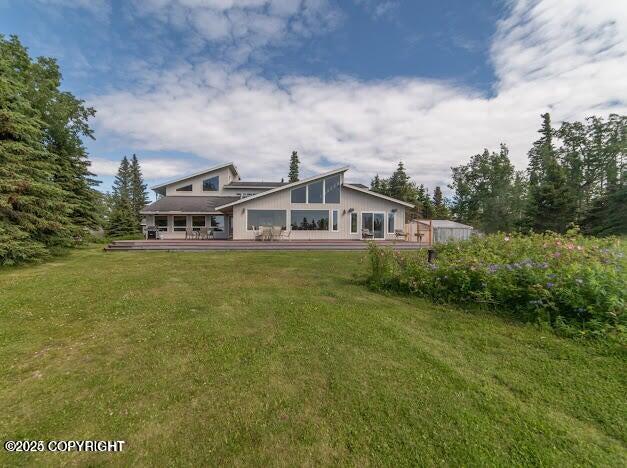 37397 Cetacea Ln, Kenai, AK 99611 - rear view of house featuring a lawn and a wooden deck