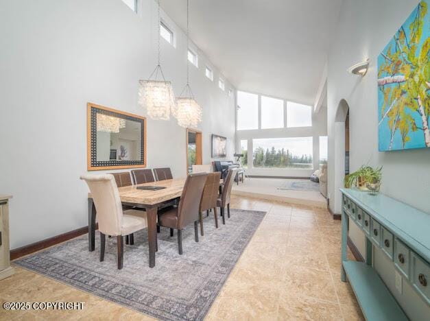 37397 Cetacea Ln, Kenai, AK 99611 - dining area with a towering ceiling, a chandelier, and arched walkways