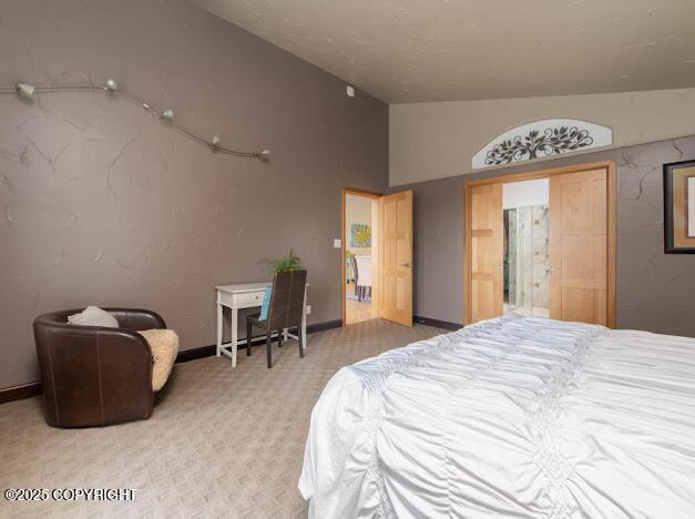 37397 Cetacea Ln, Kenai, AK 99611 - carpeted bedroom featuring lofted ceiling and baseboards