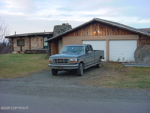 9300 Buddy Werner Dr, Anchorage, AK 99507 - view of front facade with driveway, a chimney, and an attached garage