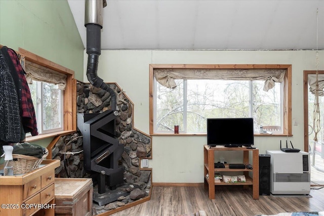 1080 Leuthold Dr, Fairbanks, AK 99712 - living room with a wood stove, wood finished floors, plenty of natural light, baseboards, and vaulted ceiling