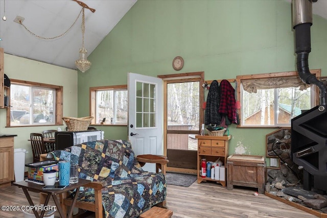 1080 Leuthold Dr, Fairbanks, AK 99712 - living room featuring wood finished floors, high vaulted ceiling, and a wood stove