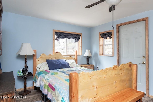 1080 Leuthold Dr, Fairbanks, AK 99712 - bedroom with wood finished floors, ceiling fan, and baseboards