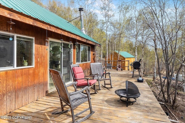 1080 Leuthold Dr, Fairbanks, AK 99712 - wooden terrace with an outdoor fire pit