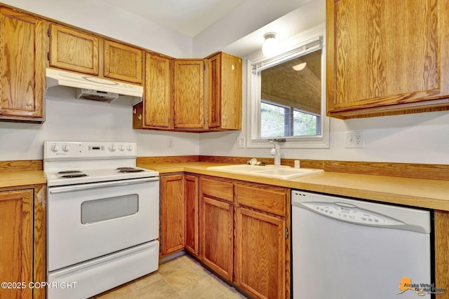 329 Gaylene Cir, Anchorage, AK 99504 - kitchen with white appliances, under cabinet range hood, a sink, and light countertops