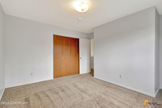 329 Gaylene Cir, Anchorage, AK 99504 - unfurnished bedroom with carpet flooring, baseboards, a closet, and a textured ceiling