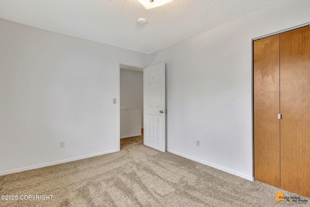 329 Gaylene Cir, Anchorage, AK 99504 - unfurnished bedroom with carpet, baseboards, a closet, and a textured ceiling
