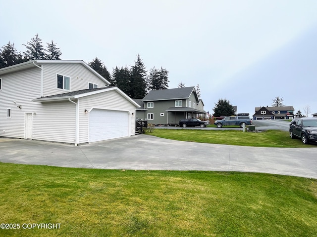 517 Sut Larsen Way, Kodiak, AK 99615 - view of side of property with a lawn, a garage, and concrete driveway