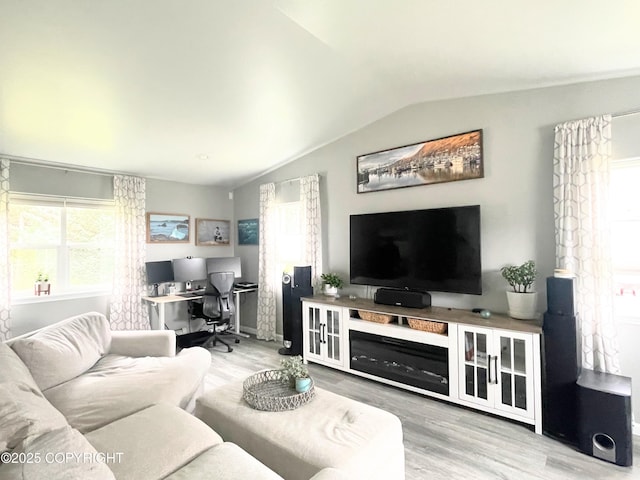 517 Sut Larsen Way, Kodiak, AK 99615 - living area featuring lofted ceiling, wood finished floors, plenty of natural light, and a desk