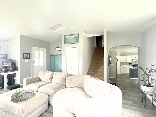 517 Sut Larsen Way, Kodiak, AK 99615 - living area featuring stairs, arched walkways, wood finished floors, and lofted ceiling