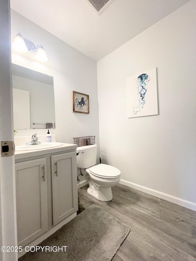 517 Sut Larsen Way, Kodiak, AK 99615 - half bath with wood finished floors, toilet, baseboards, and vanity