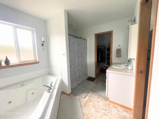 517 Sut Larsen Way, Kodiak, AK 99615 - full bath featuring vanity, a tub with jets, a walk in closet, a shower with curtain, and baseboards