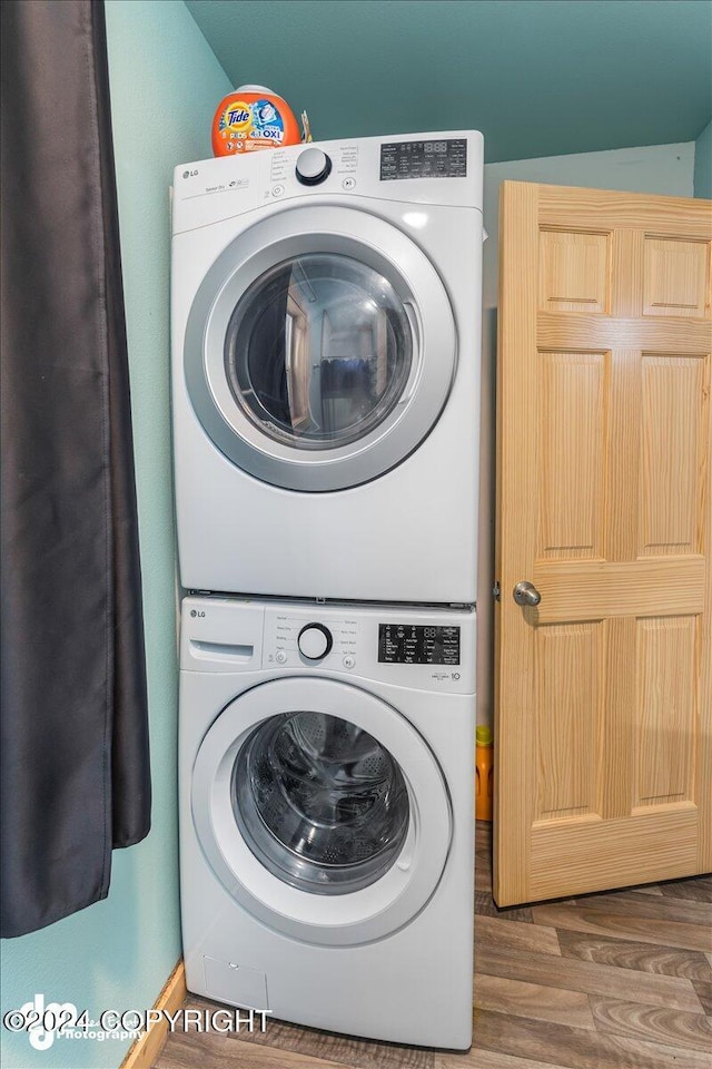 33773 Ruth Glacier Ave, Talkeetna, AK 99676 - laundry area with stacked washer / dryer and wood finished floors