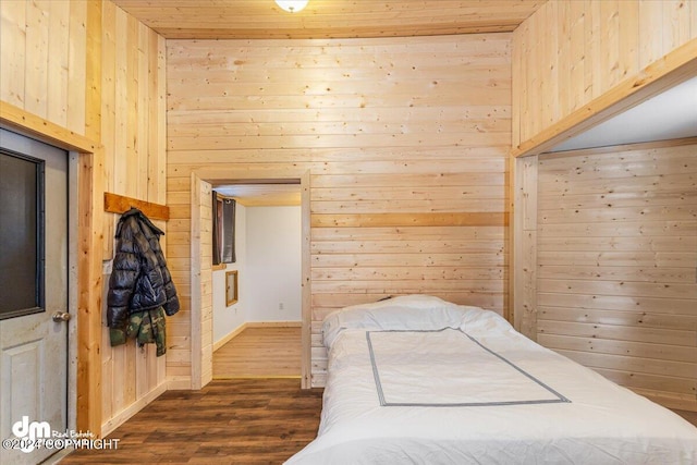 33773 Ruth Glacier Ave, Talkeetna, AK 99676 - bedroom featuring wooden walls, dark wood-style floors, and baseboards