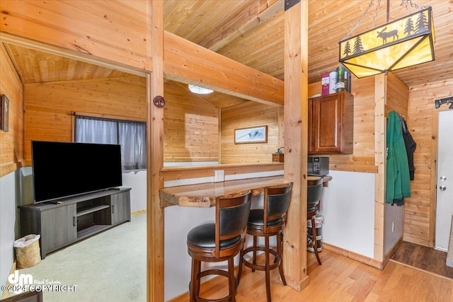 33773 Ruth Glacier Ave, Talkeetna, AK 99676 - kitchen with wooden walls, wooden ceiling, brown cabinets, wood finished floors, and a kitchen bar
