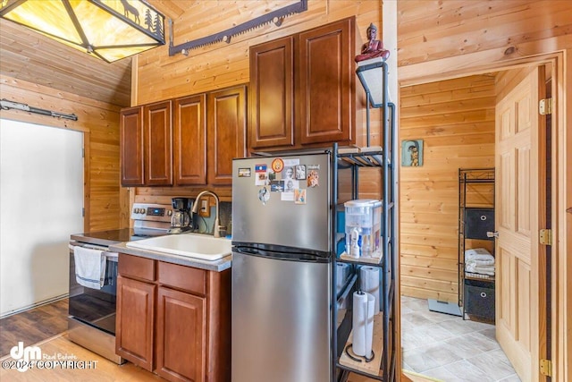 33773 Ruth Glacier Ave, Talkeetna, AK 99676 - kitchen featuring stainless steel appliances, wooden walls, and a sink