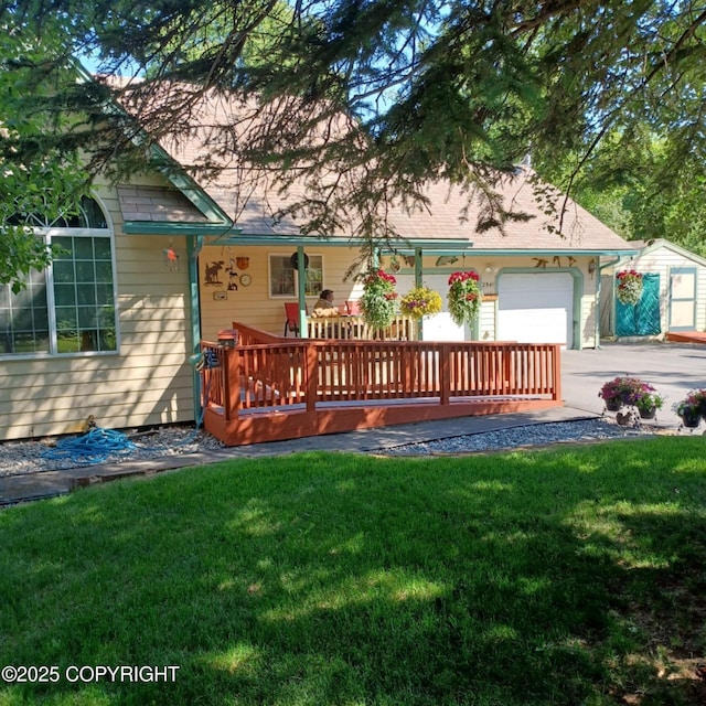 2541 S Teeland St, Wasilla, AK 99623 - back of house featuring driveway, a garage, a yard, and a wooden deck
