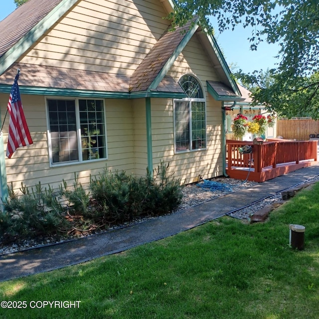 2541 S Teeland St, Wasilla, AK 99623 - view of side of property featuring a lawn and a wooden deck