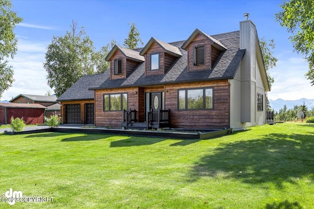 174 E Leota St, Wasilla, AK 99654 - view of front of house with an attached garage, a chimney, a front yard, and roof with shingles